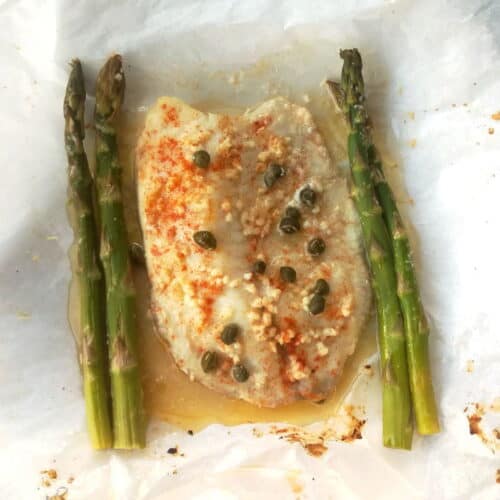 fish in parchment paper with capers and asparagus