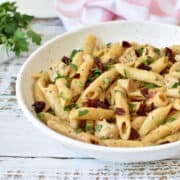Penne pasta with chicken, dried tomatoes and parsley with cream cheese sauce