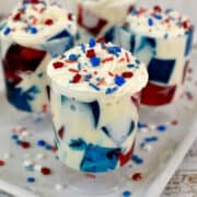 red and blue gelatin with white cream, whipped cream and sprinkles on top