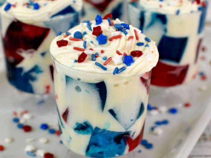 red and blue gelatin with white cream, whipped cream and sprinkles on top
