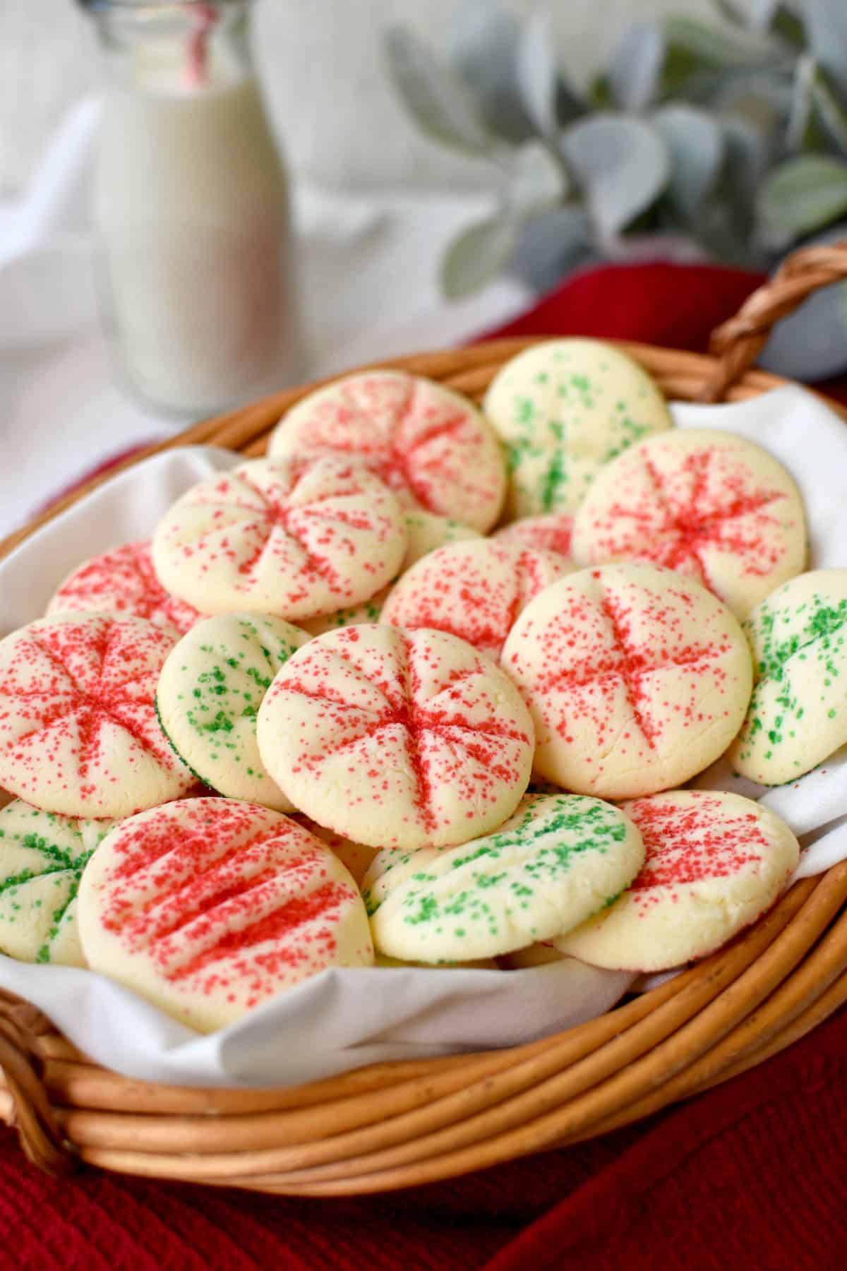 3-ingredient shortbread cookies in a basket with a glass of milk in the back