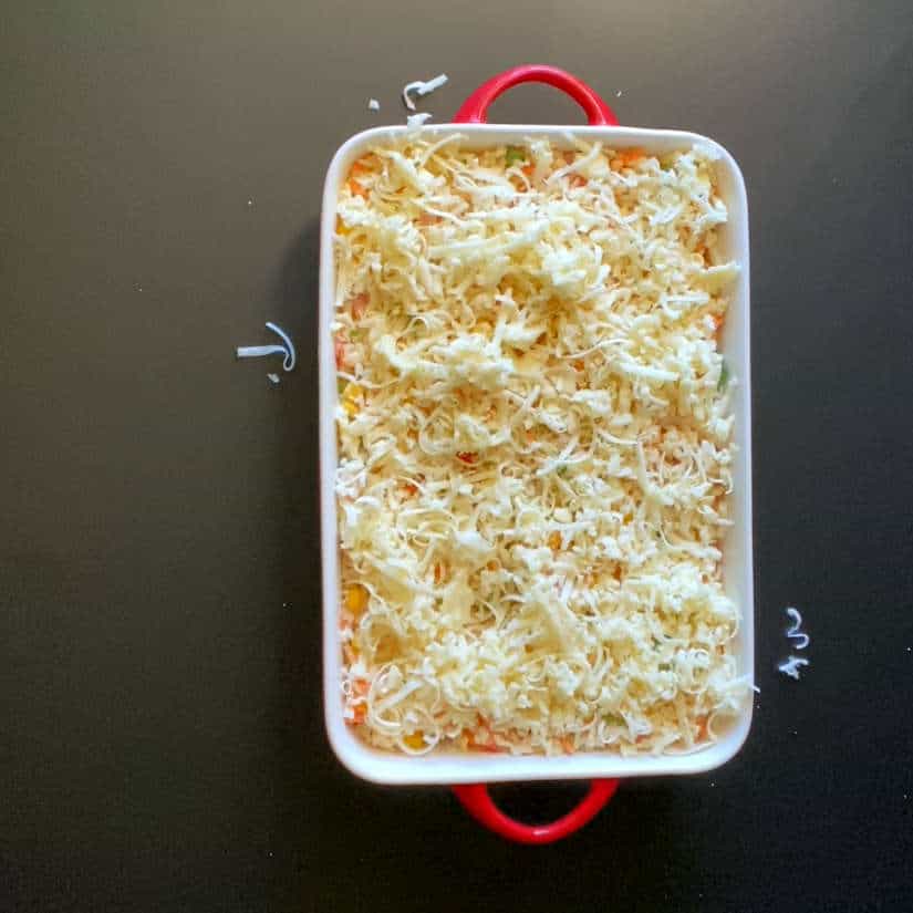 casserole with rice mixture, cheese and oregano on top
