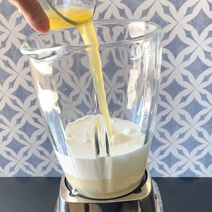 adding sweetened condensed milk, heavy cream and lemon juice to the blender cup.