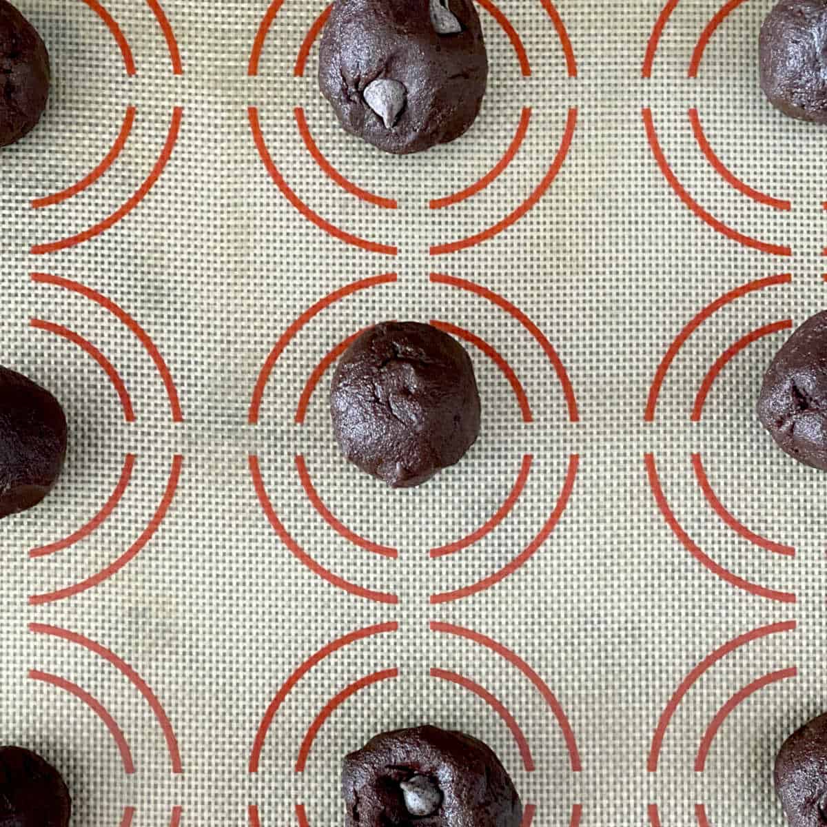 raw cookie dough portioned on sheet pan.