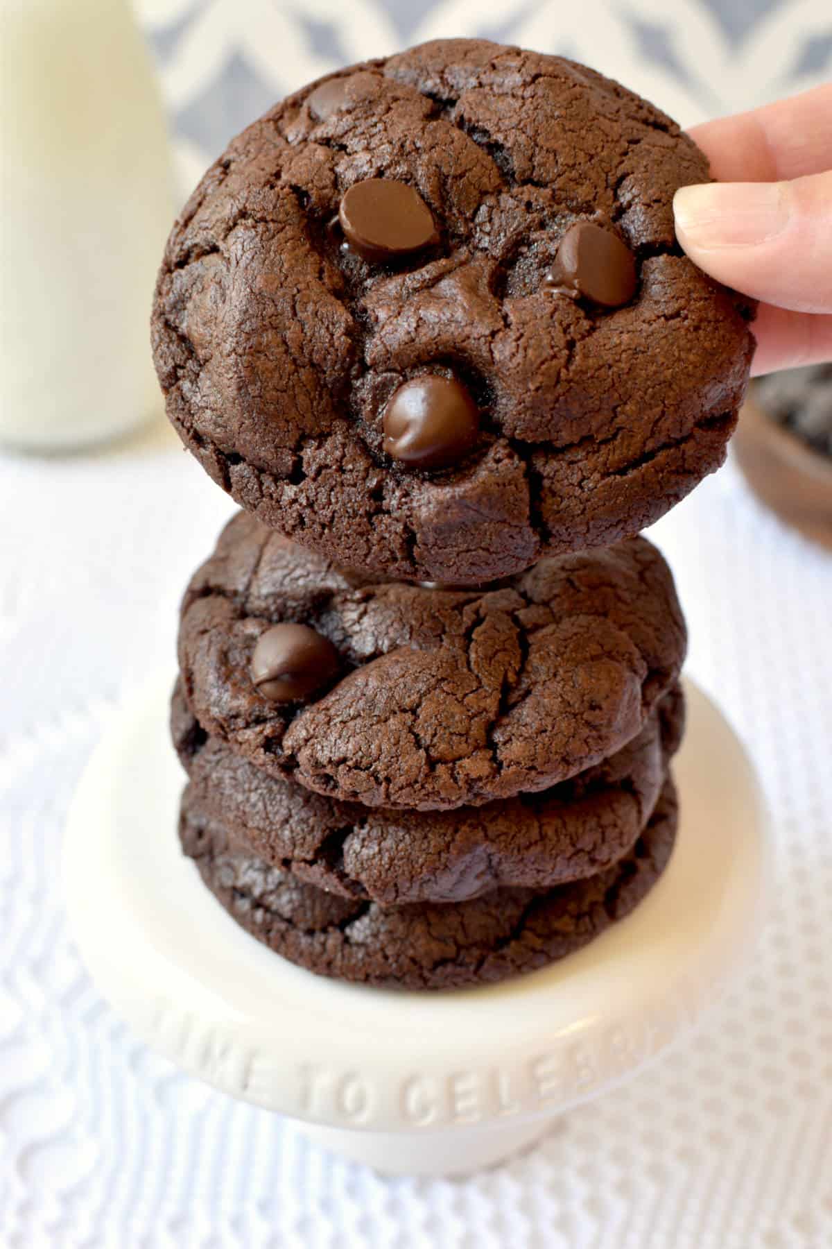 chocolate chocolate chips cookies with a hand holding one.