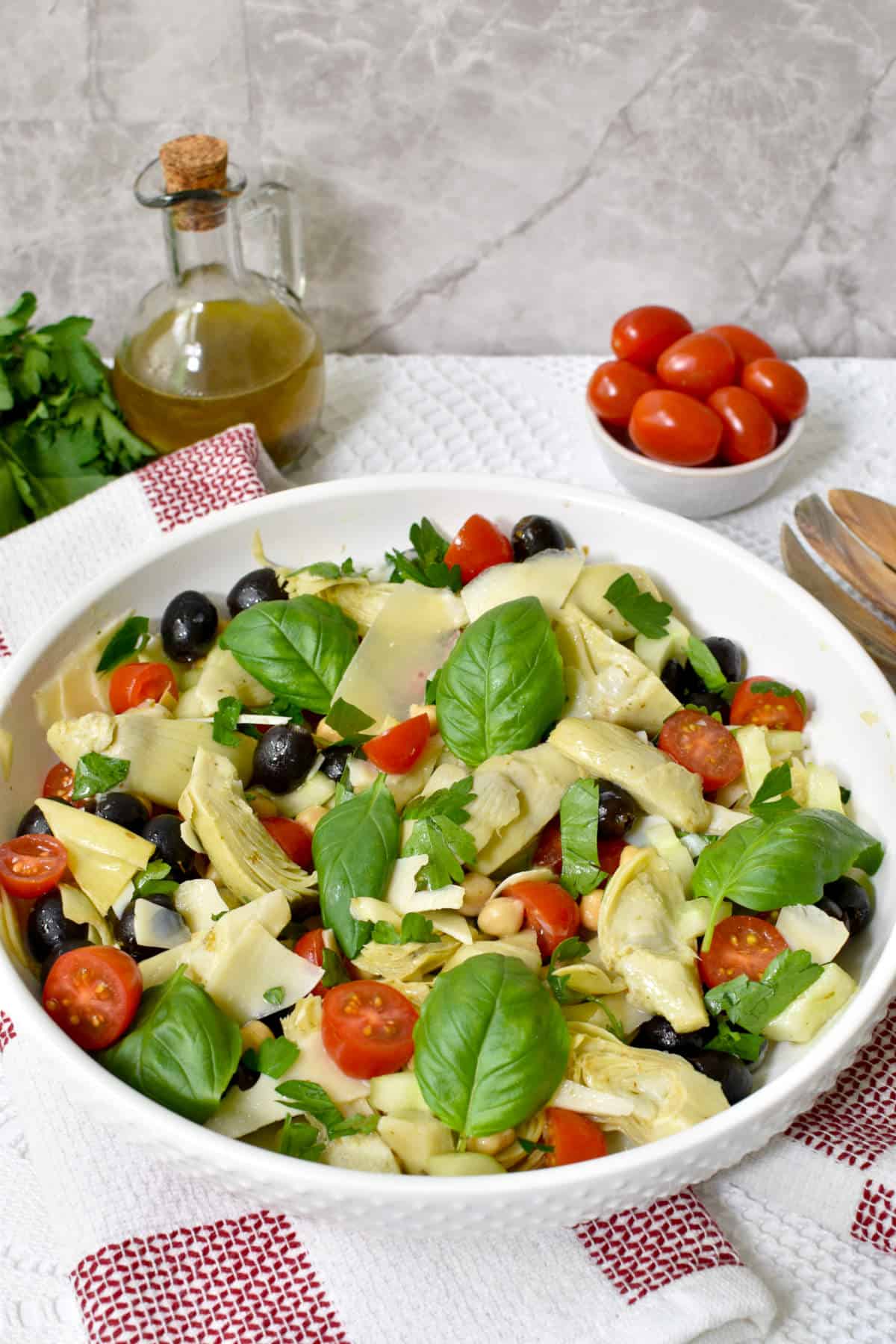 salad made with canned artichokes, black olives, tomatoes, cheese and basil leaves.