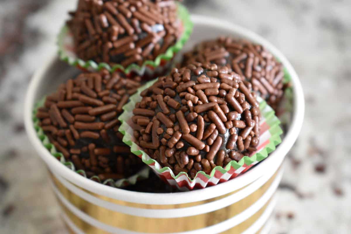 Brigadeiros inside a white and gold paper cup