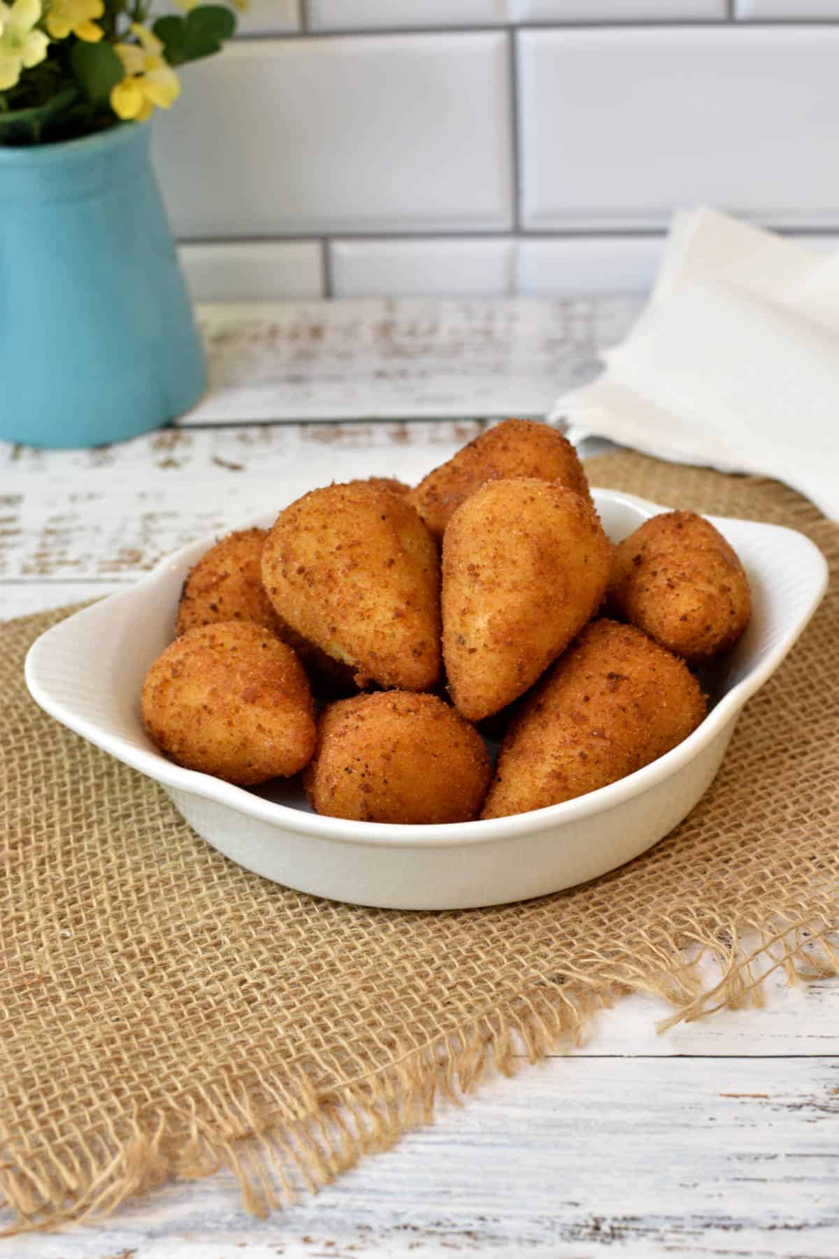 Some Brazilian chicken croquettes in a shallow white dish