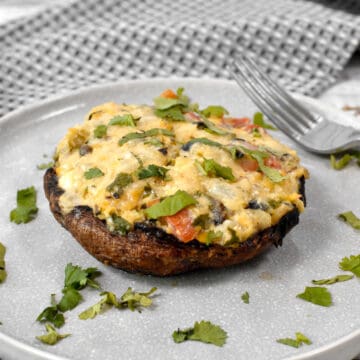 Portobello mushroom stuffed with vegetables, legumes, and cheese, topped with cilantro.