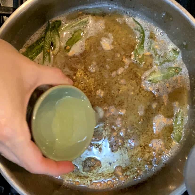 Adding lemon juice to browned butter sauce.